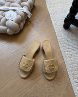 Channel quilted lambskin mules featuring a gold-tone chain and CC logo detail