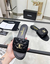 Channel flat slide slipper adorned with the iconic gold-tone Chanel CC logo