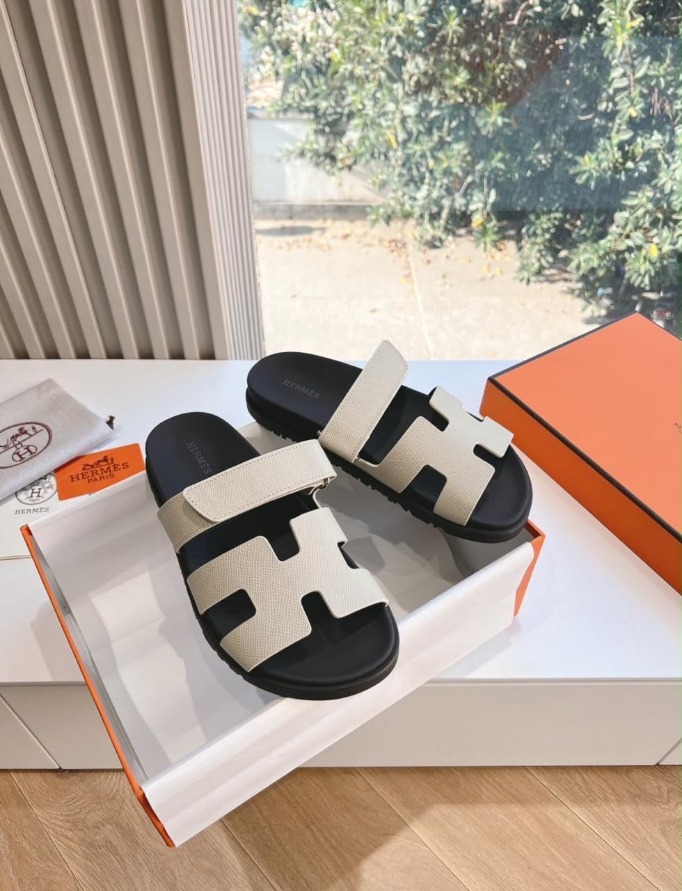 Hermès Chypre sandals featuring the iconic cutout "H" vamp and an adjustable upper strap