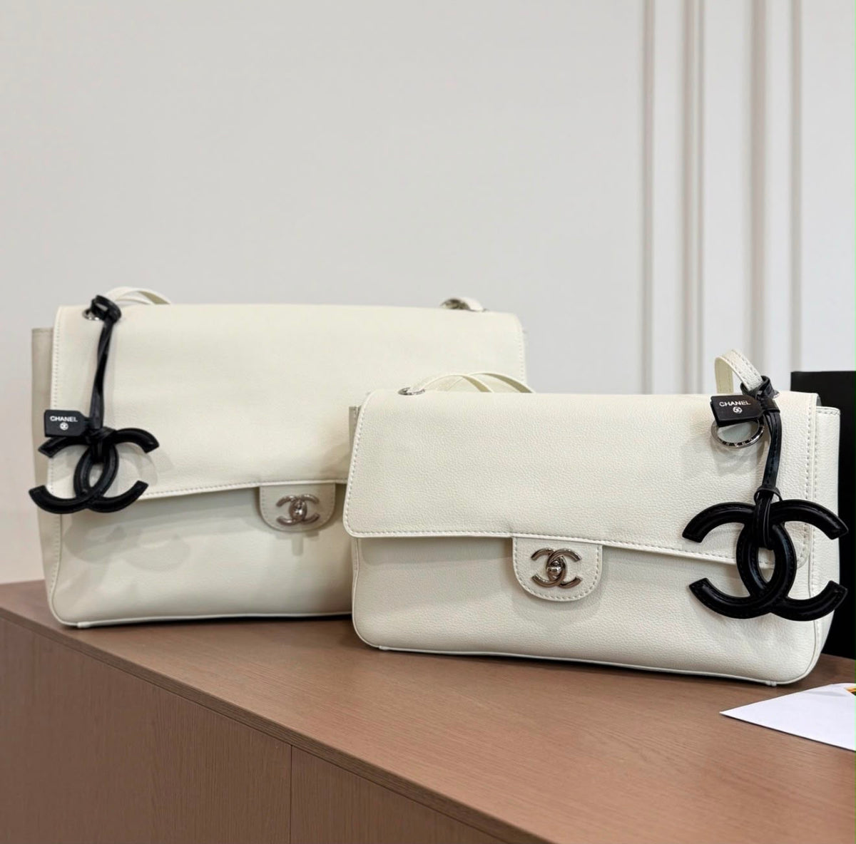 Chanel Maxi Flap Bag is crafted grained calfskin with silver metal and features a distinctive CC charm accent