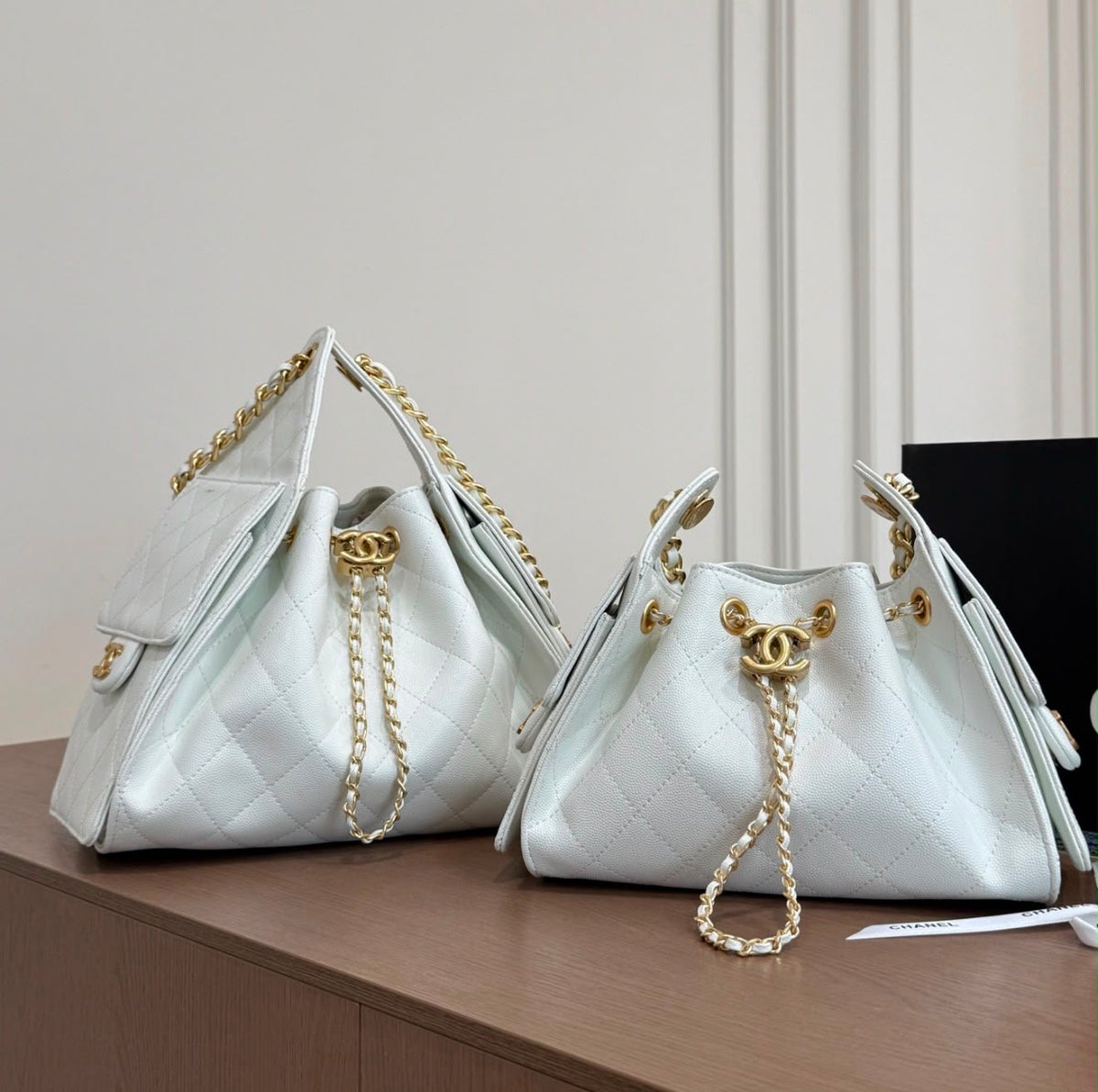 suede Chanel 25 handbags feature diamond quilting and iconic goldand silver tone CC chain drawstrings