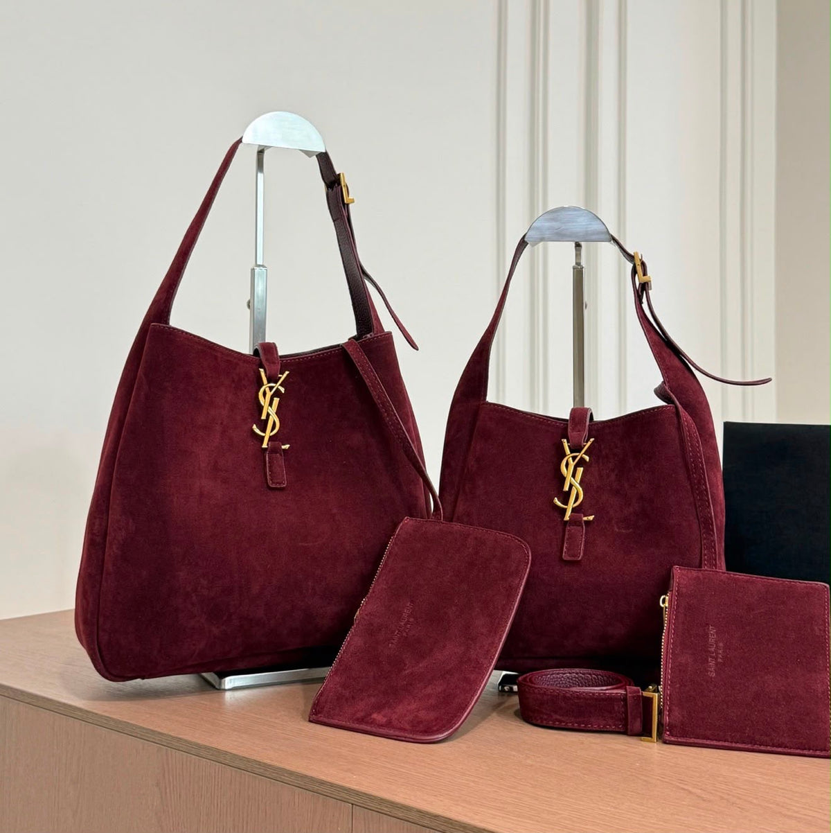 The Saint Laurent Le 5 à 7 Supple Large shoulder bag suede features the iconic gold-tone Cassandre hook closure and a relaxed, slouchy silhouette
