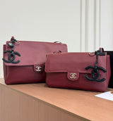 Chanel Maxi Flap Bag is crafted grained calfskin with silver metal and features a distinctive CC charm accent