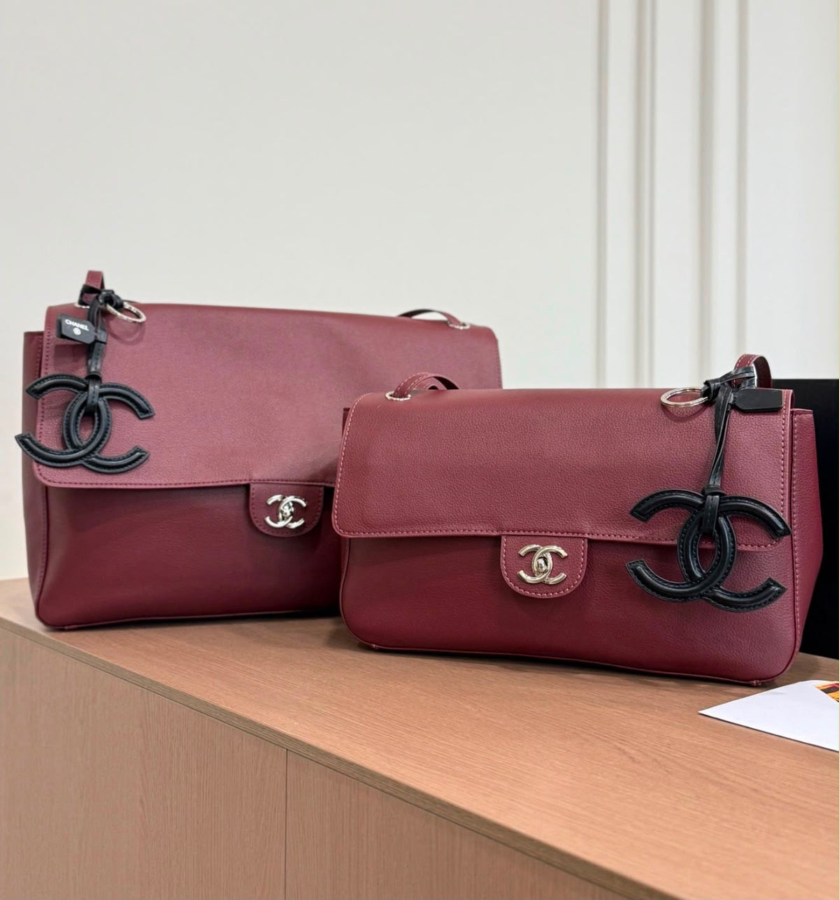Chanel Maxi Flap Bag is crafted grained calfskin with silver metal and features a distinctive CC charm accent