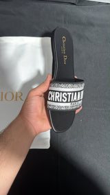 Dior Dway slides featuring the signature white "Christian Dior Paris" lettering across the upper strap