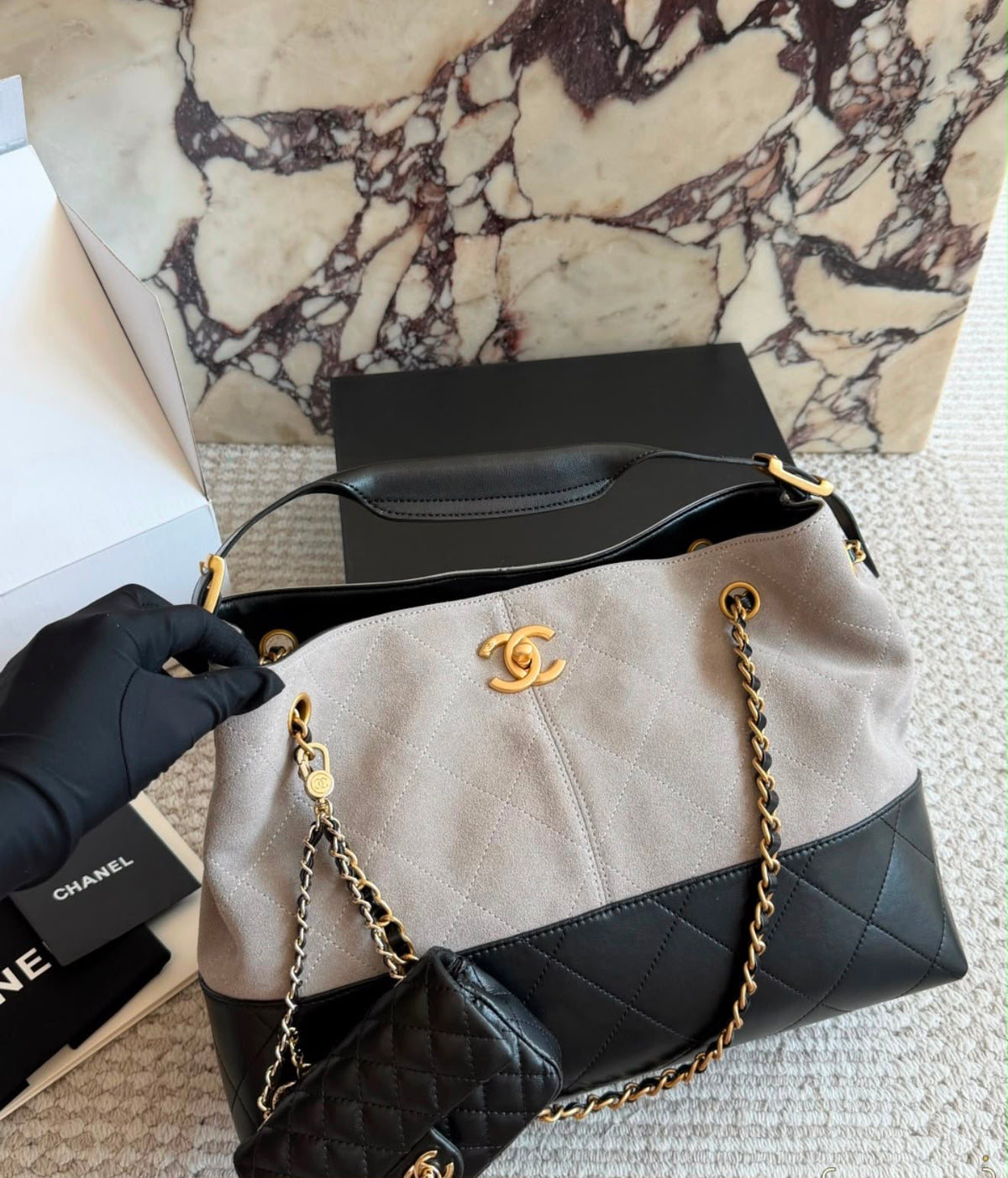 This is the Chanel Small Coco Base Shopping Bag in grey/ camel suede and black lambskin with aged gold-tone hardware