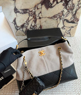This is the Chanel Small Coco Base Shopping Bag in grey/ camel suede and black lambskin with aged gold-tone hardware