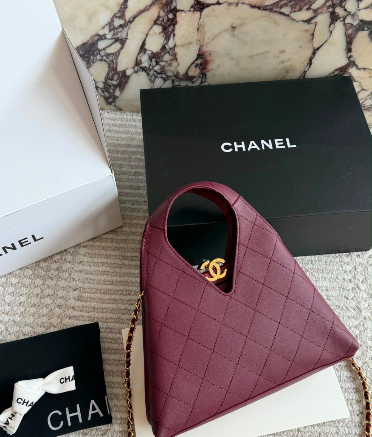 quilted calfskin Chanel shopping bag from the Métiers d'art collection features a distinctive V-cut top opening and gold-tone hardware