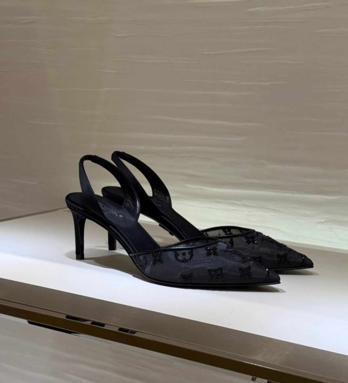 Louis Vuitton Gala Slingback Pumps in black translucent mesh adorned with shimmering Swarovski rhinestone monogram details