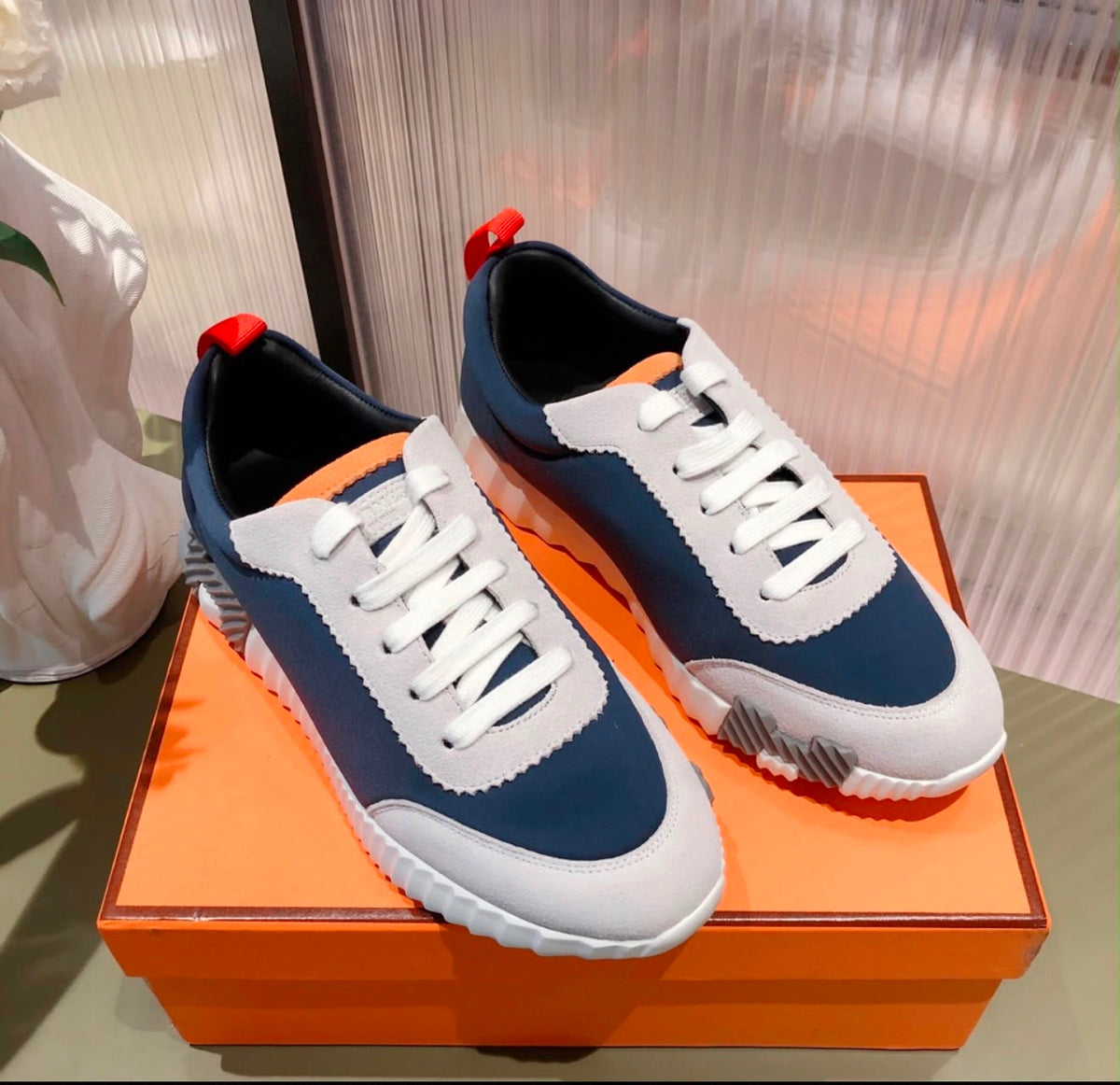 Hermés bouncing sneakers pull-tabs and a graphic ridged rubber sole