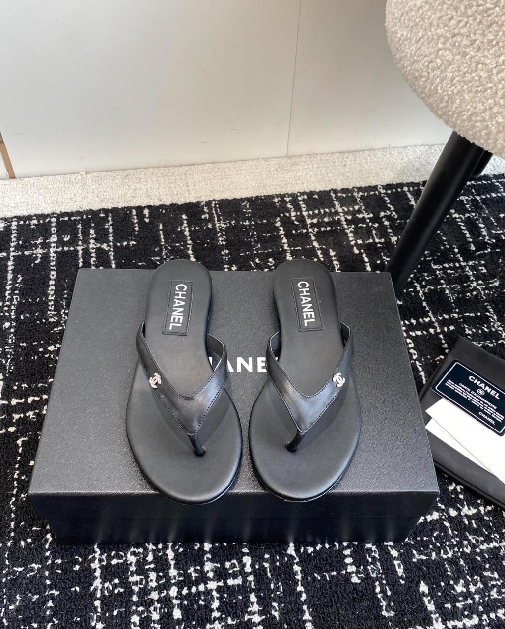 Chanel Black Shiny Lambskin Crystal CC Thong Sandals, featuring a sleek leather finish and a subtle crystal-embellished CC logo on the strap
