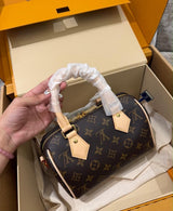 Louis Vuitton Speedy Bandoulière in Monogram canvas features signature cowhide leather trim and protective packaging wrapped around the top handle