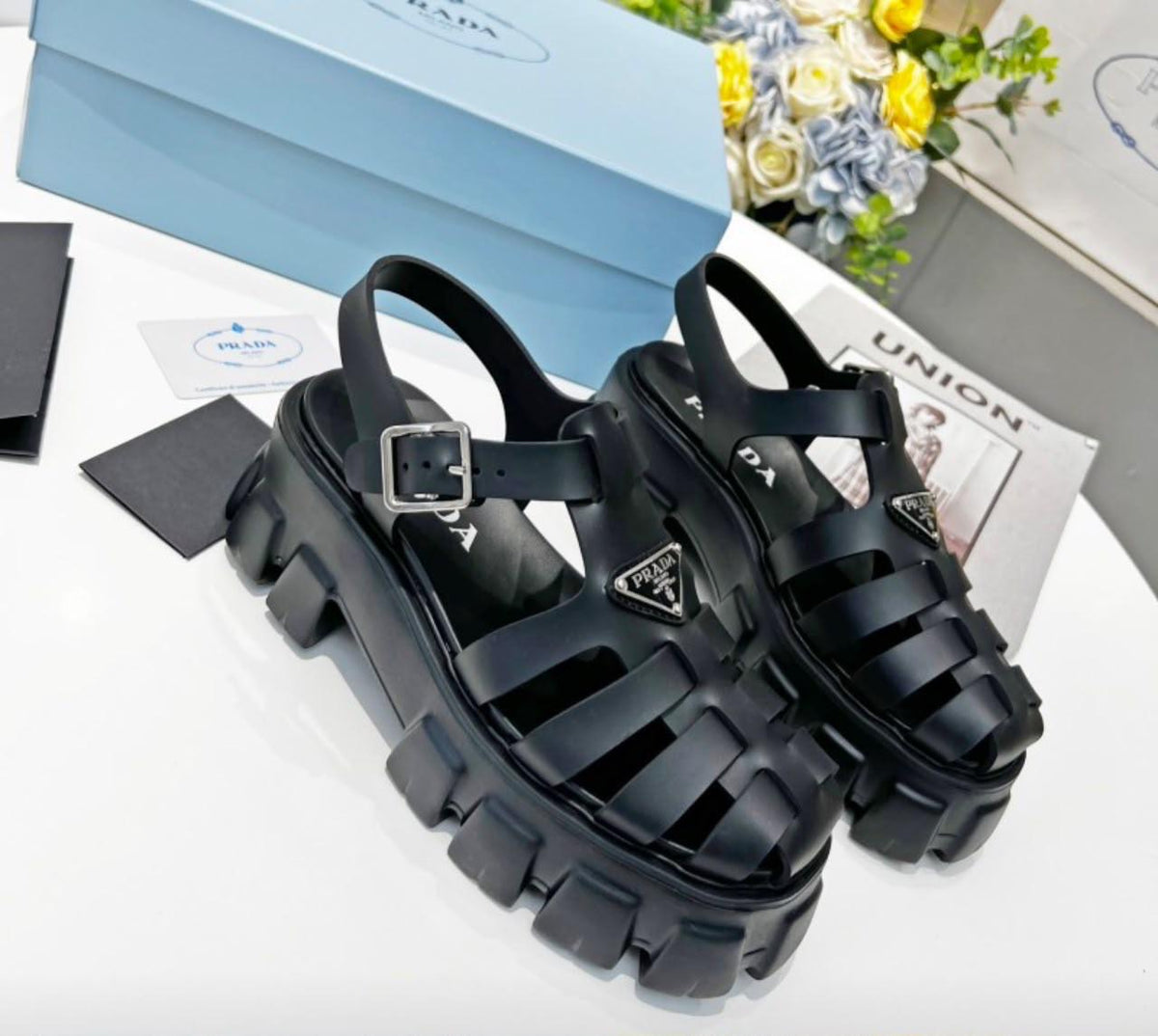 Prada Monolith crochet cage sandals, featuring a chunky lug sole and a woven, raffia-effect upper accented with the brand's signature metal triangle logo.( from 35-to 42)
