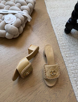 Channel quilted lambskin mules featuring a gold-tone chain and CC logo detail