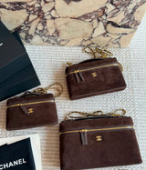 This is a Chanel Slim Long Vanity Case with Chain suede featuring gold tone hardware