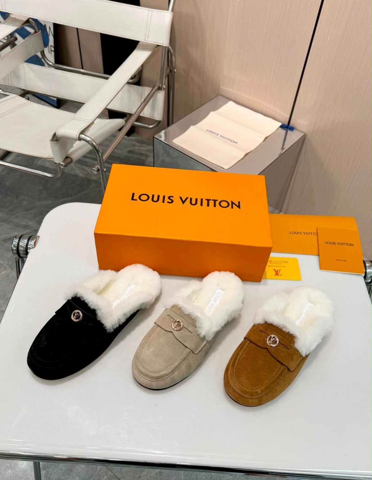 Louis Vuitton Soho Open Back Loafers crafted in soft suede calf leather with a plush shearling lining and a gold-toned LV Circle accessory