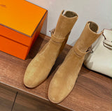 suede Hermès Frenchie 50 ankle boots, featuring a wrap-around strap and a distinctive palladium-plated Kelly buckle