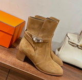 suede Hermès Frenchie 50 ankle boots, featuring a wrap-around strap and a distinctive palladium-plated Kelly buckle