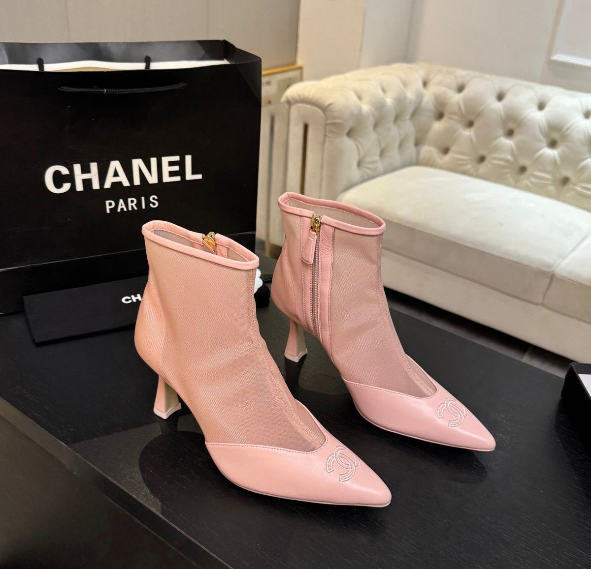 These are pink mesh and leather pointed-toe ankle booties featuring a delicate embroidered CC logo on the toe