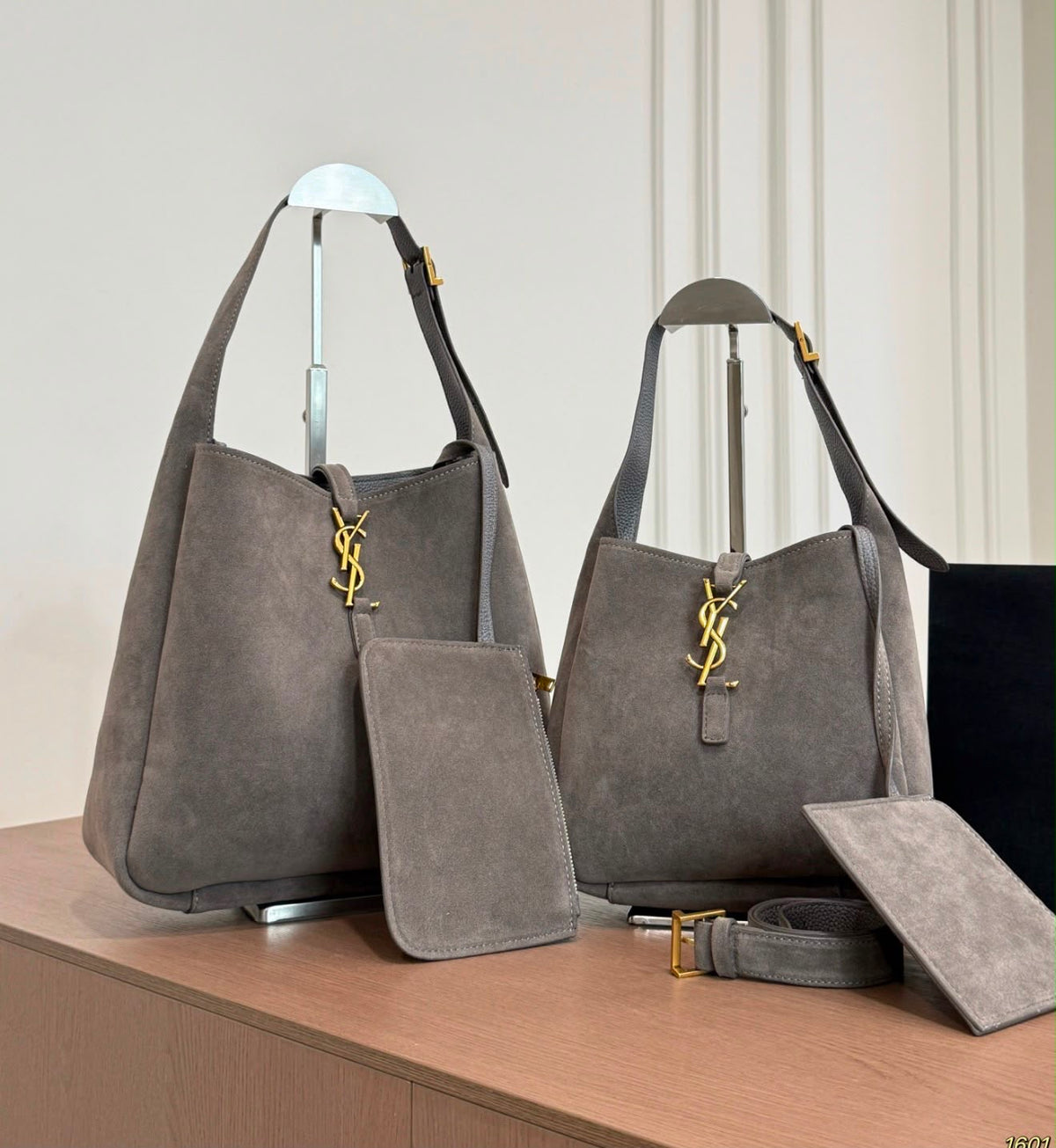 The Saint Laurent Le 5 à 7 Supple Large shoulder bag suede features the iconic gold-tone Cassandre hook closure and a relaxed, slouchy silhouette