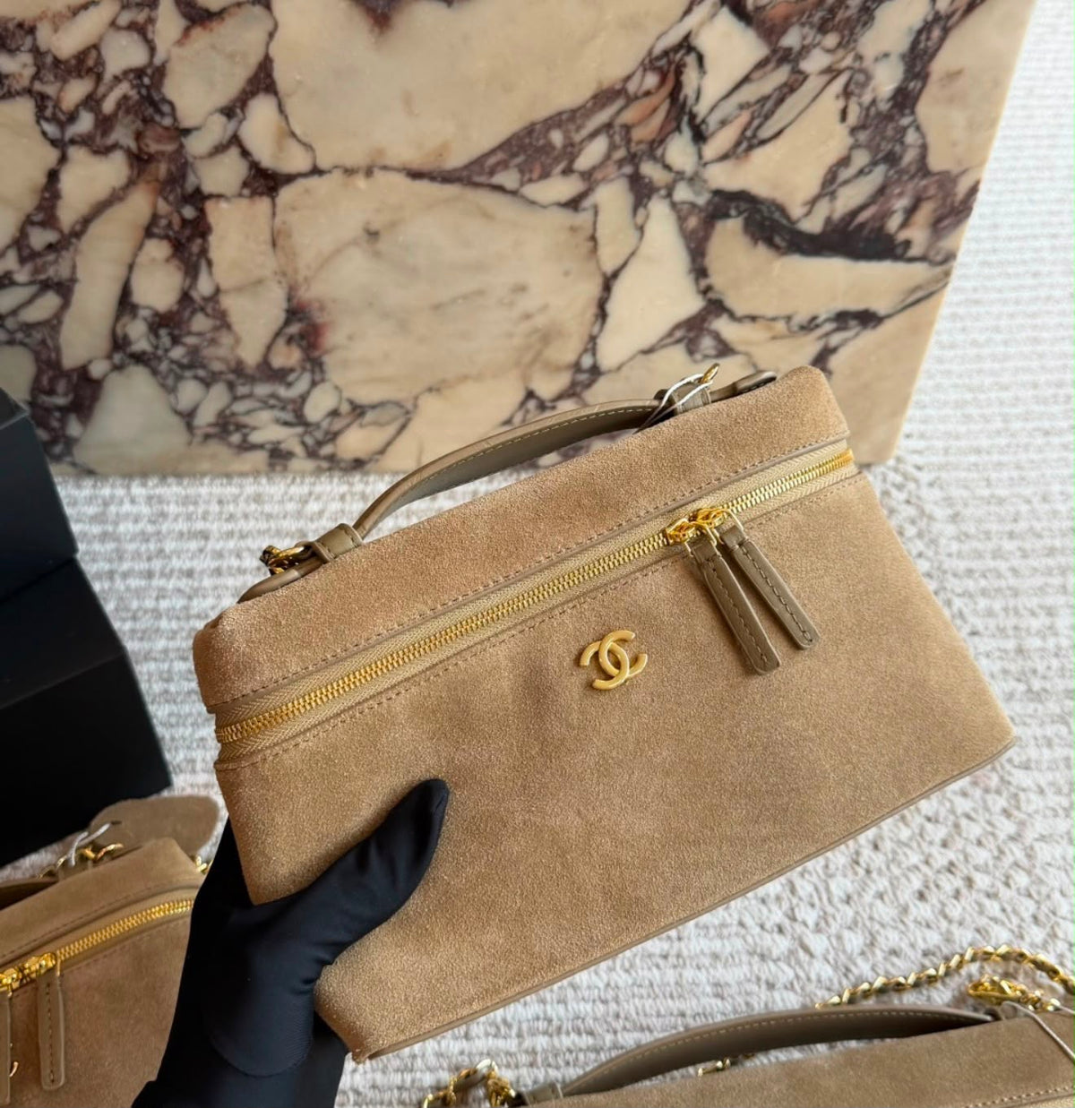 This is a Chanel Slim Long Vanity Case with Chain suede featuring gold tone hardware