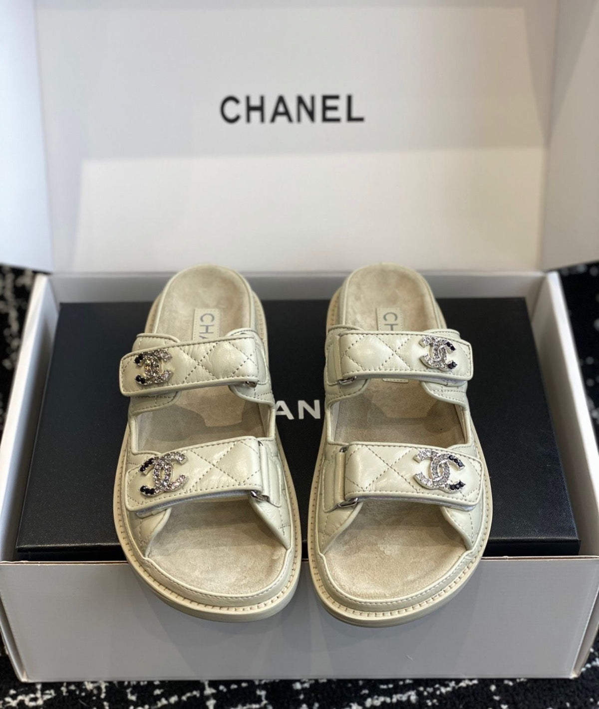 Chanel quilted lambskin dad sandals in a beige with double velcro straps and crystal-embellished CC logos