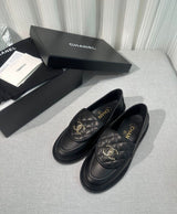 lambskin quilted CC turn-lock loafers by Chanel, featuring a quilted tongue detail with a gold-tone CC turn-lock closure