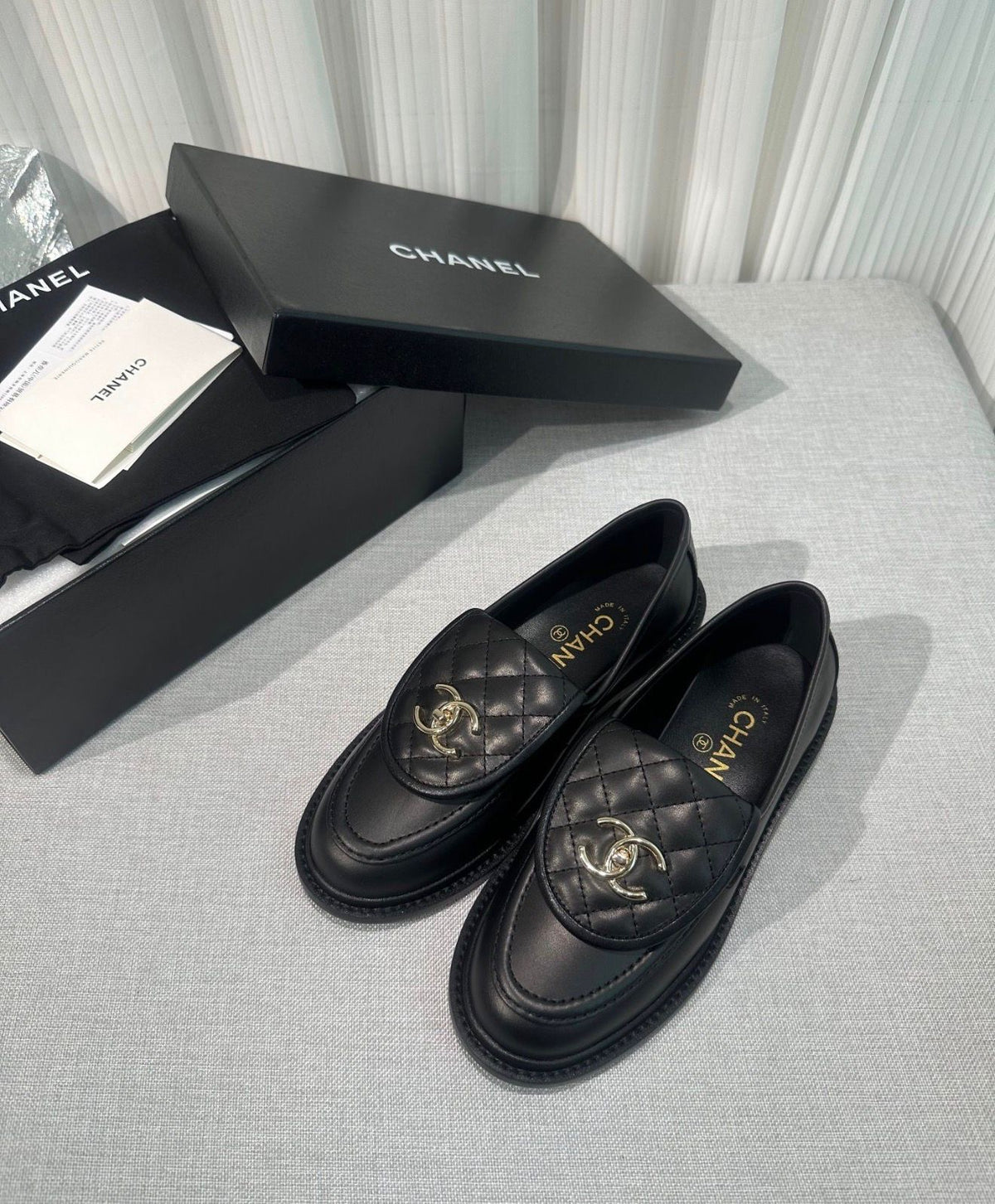 lambskin quilted CC turn-lock loafers by Chanel, featuring a quilted tongue detail with a gold-tone CC turn-lock closure