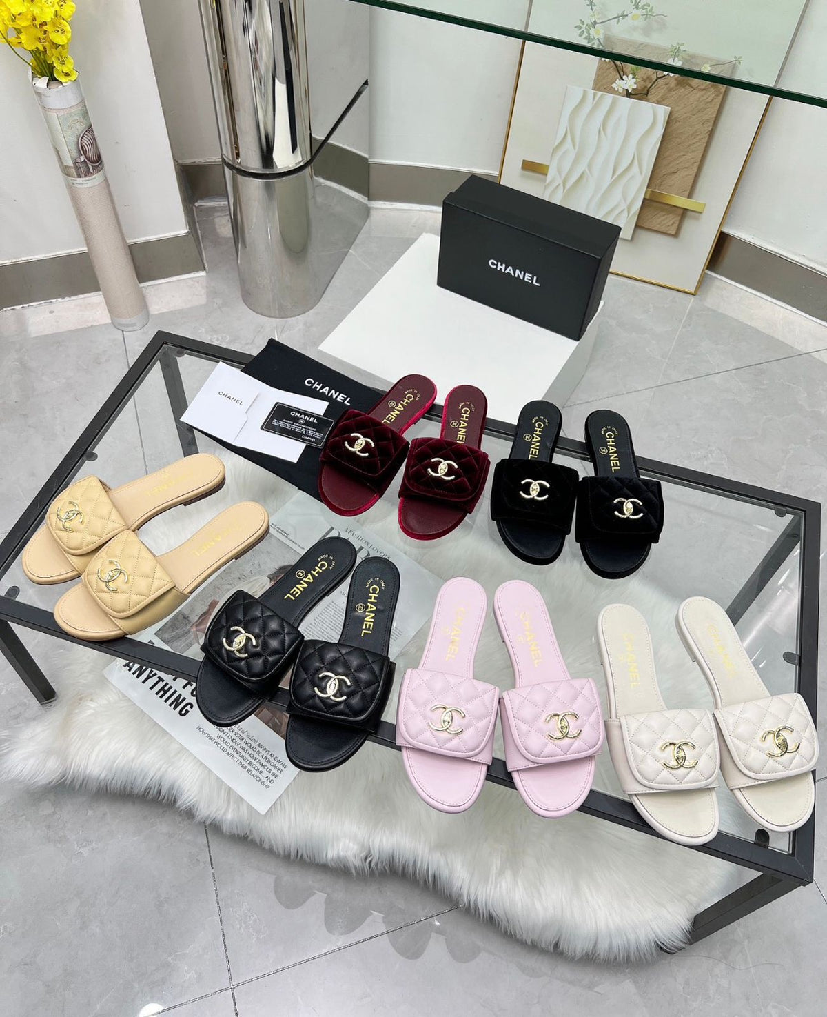 Channel flat slide slipper adorned with the iconic gold-tone Chanel CC logo