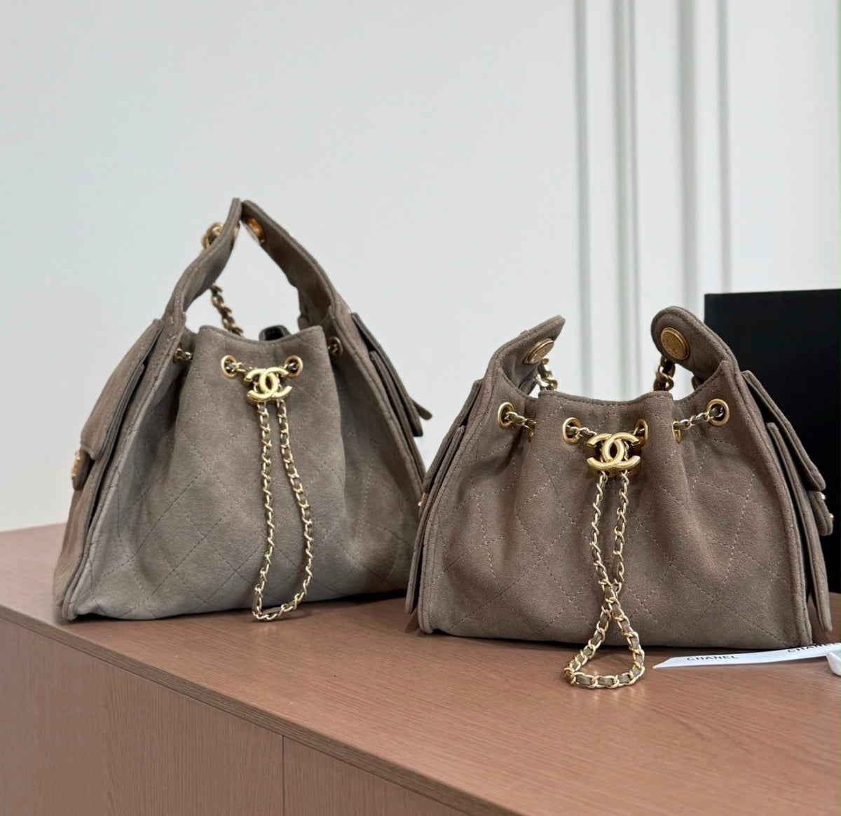 suede Chanel 25 handbags feature diamond quilting and iconic goldand silver tone CC chain drawstrings