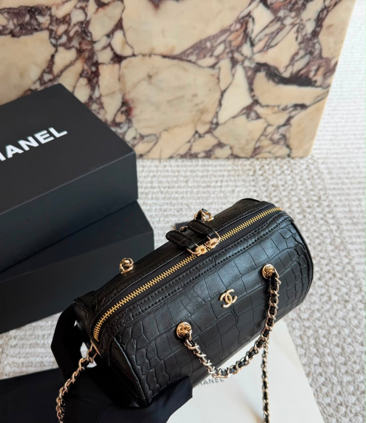 This stylish Chanel Croc-Embossed Bowling Cylinder Bag is beautifully crafted in black embossed leather with gleaming gold-tone hardware