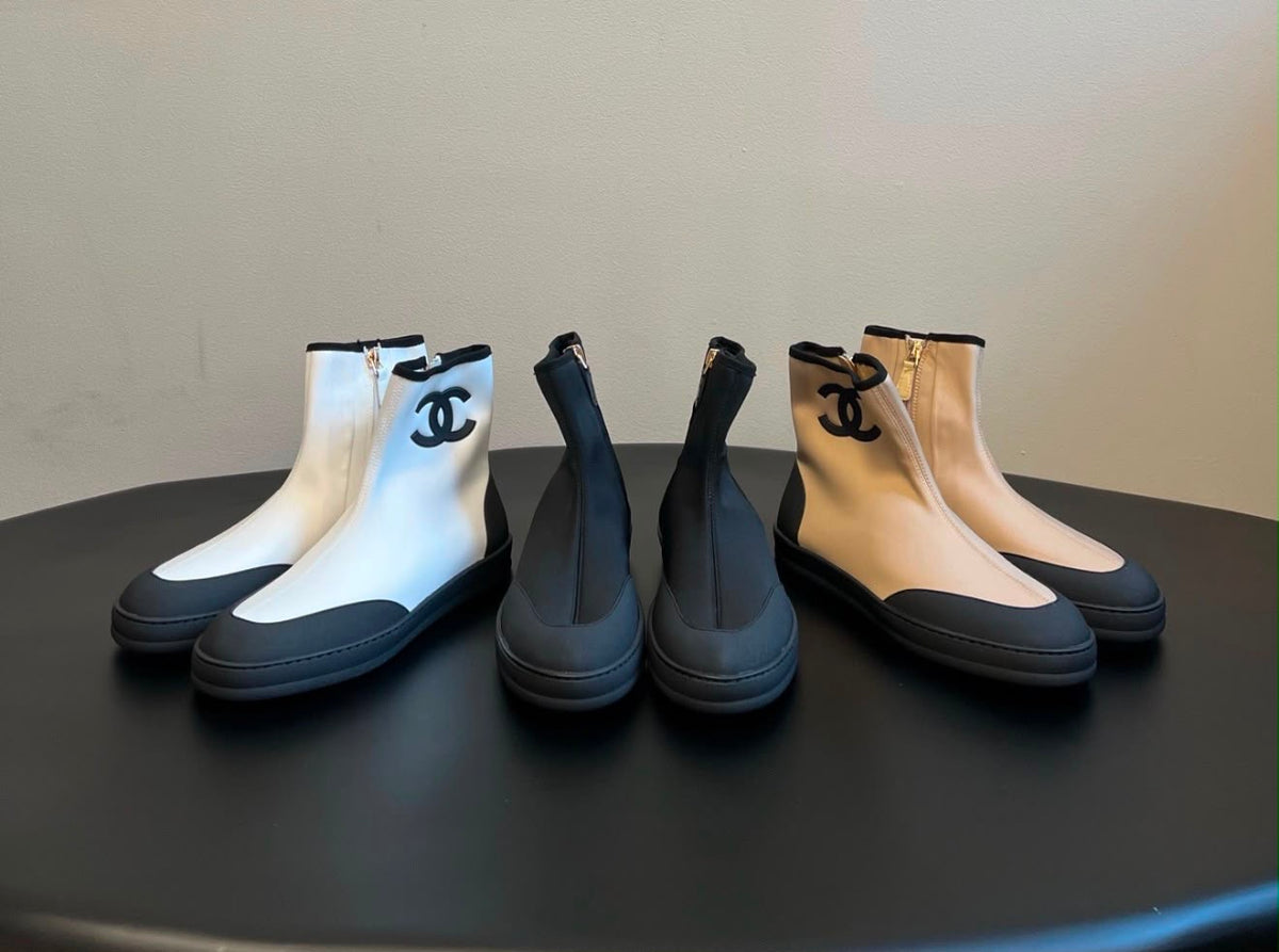 Chanel Lambskin & Knit Sock Ballet Flats featuring a smooth leather toe cap with a delicate bow and a ribbed knit sock upper accented with the iconic CC logo