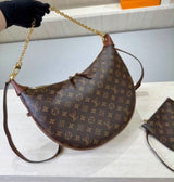 Louis Vuitton Loop Hobo in Monogram canvas with its distinctive half-moon silhouette accented by a gleaming gold-tone chain