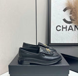 black lambskin Chanel Emblematics Moccasins featuring quilted detailing and an ornate jeweled CC logo embellishment