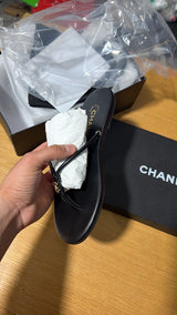 black leather thong slipper featuring a delicate gold-tone interlocking CC logo at the front.