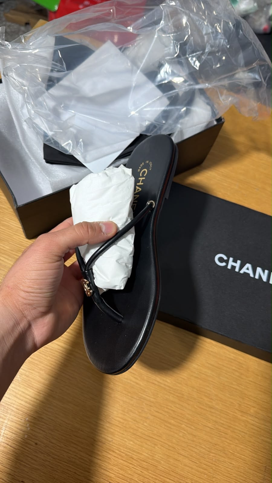 black leather thong slipper featuring a delicate gold-tone interlocking CC logo at the front.