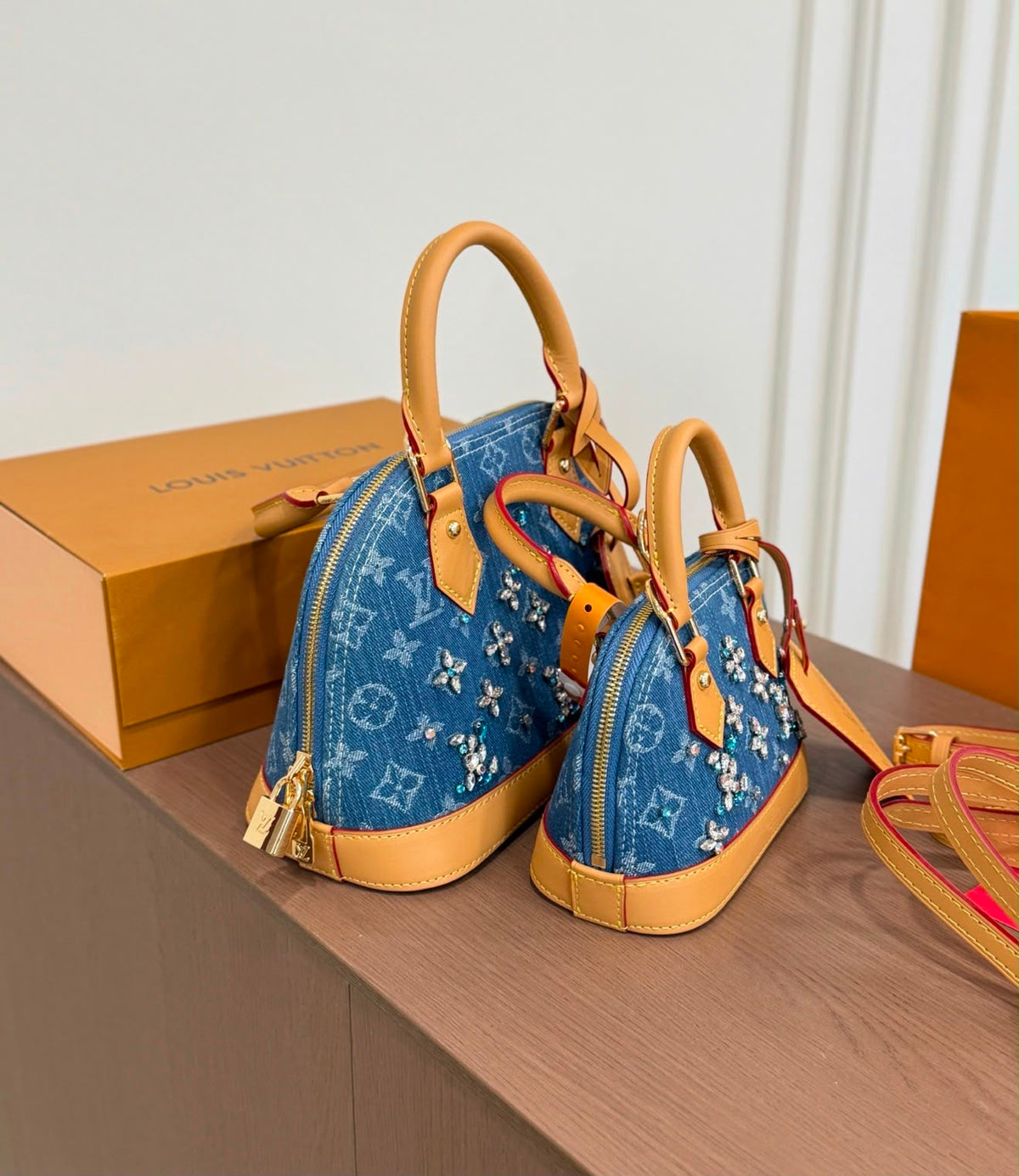 Louis Vuitton Alma BB and Nano Alma handbags crafted in blue Monogram denim and embellished with sparkling crystal floral clusters