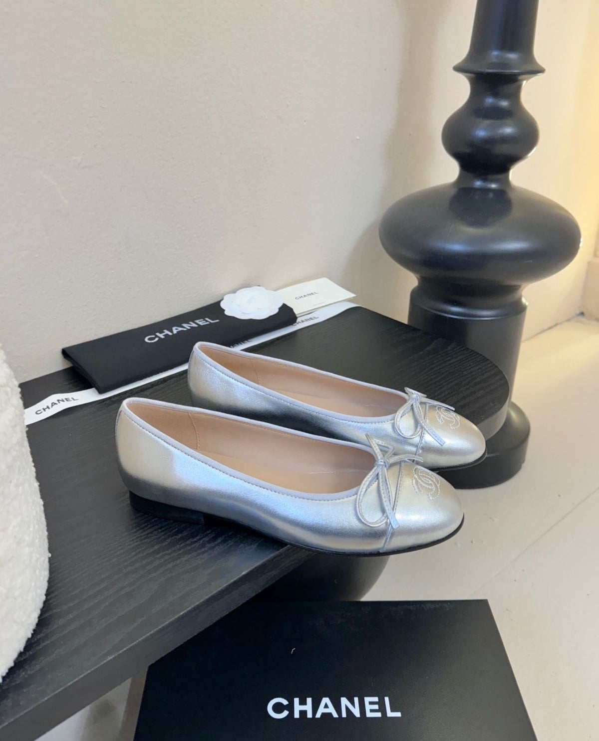 quilted leather ballet flats by Chanel, featuring the iconic interlocking CC logo and a delicate bow on the toe