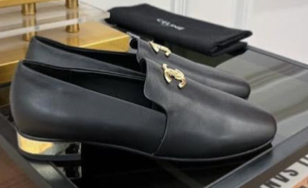 These are black leather Chanel CC logo loafers featuring polished gold-tone interlocking CC hardware on the vamp