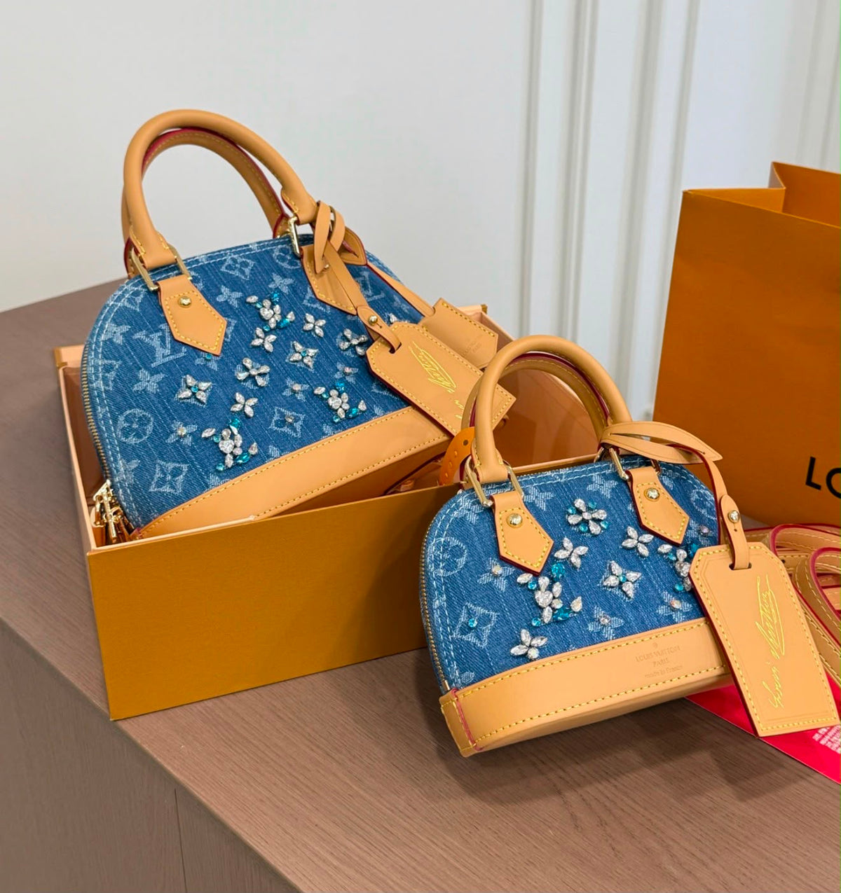 Louis Vuitton Alma BB and Nano Alma handbags crafted in blue Monogram denim and embellished with sparkling crystal floral clusters