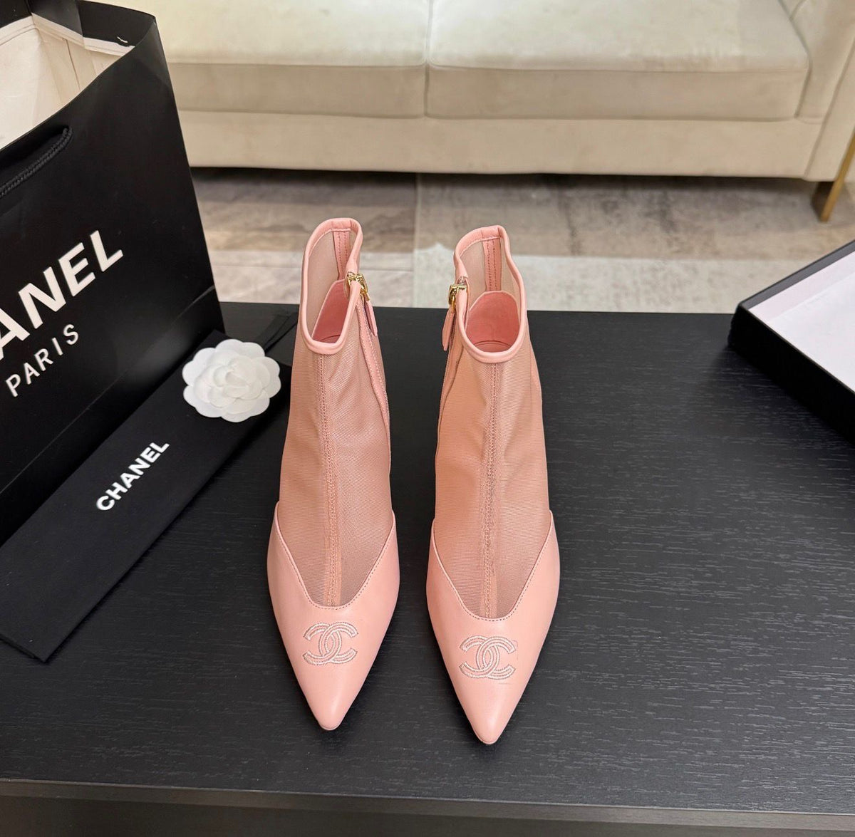 These are pink mesh and leather pointed-toe ankle booties featuring a delicate embroidered CC logo on the toe