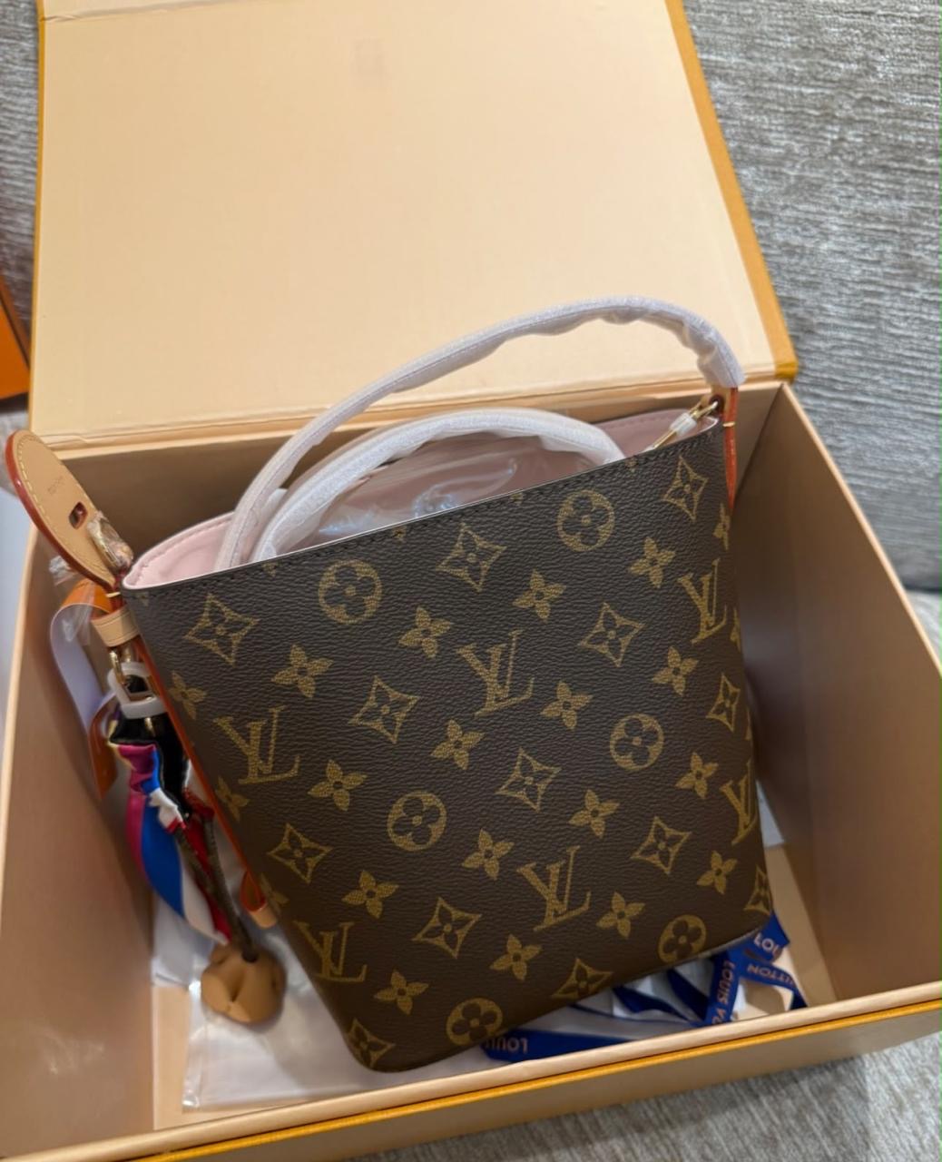 Louis Vuitton All In BB bucket bag in the iconic Monogram canvas featuring a structured silhouette and a pink interior lining