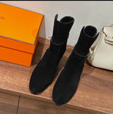 suede Hermès Frenchie 50 ankle boots, featuring a wrap-around strap and a distinctive palladium-plated Kelly buckle
