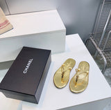 black leather Chanel thong flip-flop sandals featuring gold-tone interlocking CC logo hardware on the straps