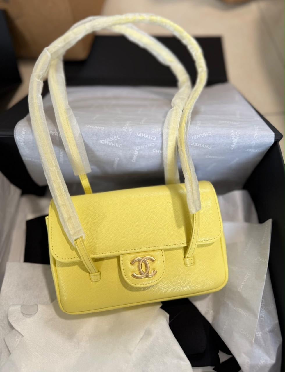Chanel Preppy Coco Mini Flap Bag in black grained shiny calfskin, featuring dual slender shoulder straps and an iconic gold-tone CC turn-lock.
