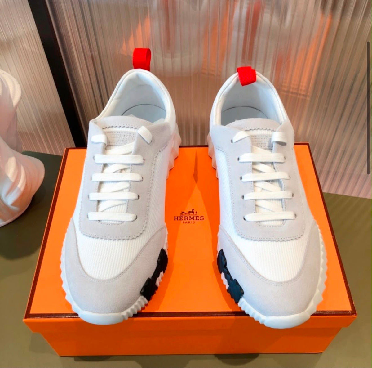 Hermés bouncing sneakers pull-tabs and a graphic ridged rubber sole