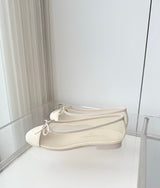 quilted leather ballet flats by Chanel, featuring the iconic interlocking CC logo and a delicate bow on the toe