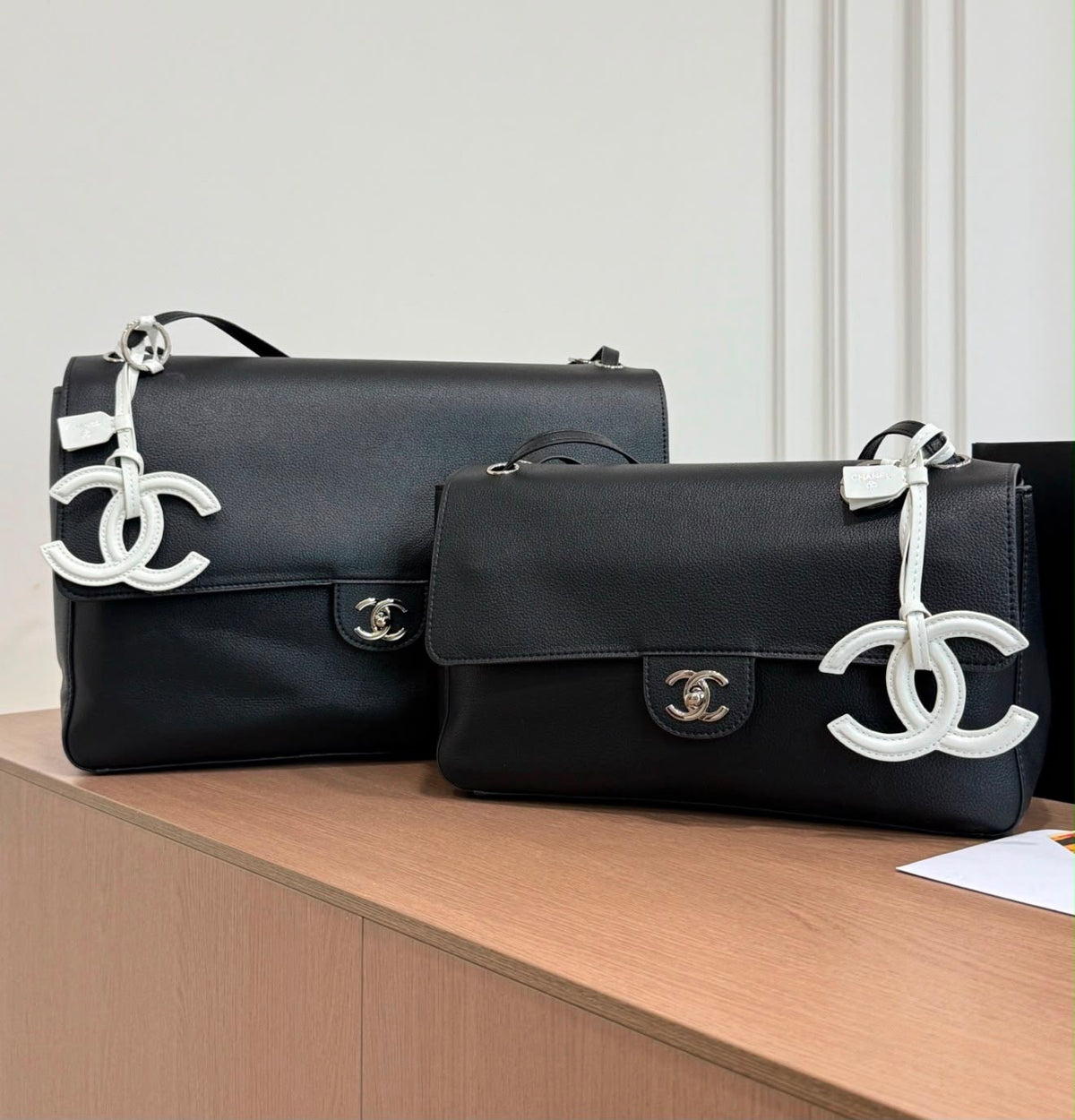 Chanel Maxi Flap Bag is crafted grained calfskin with silver metal and features a distinctive CC charm accent