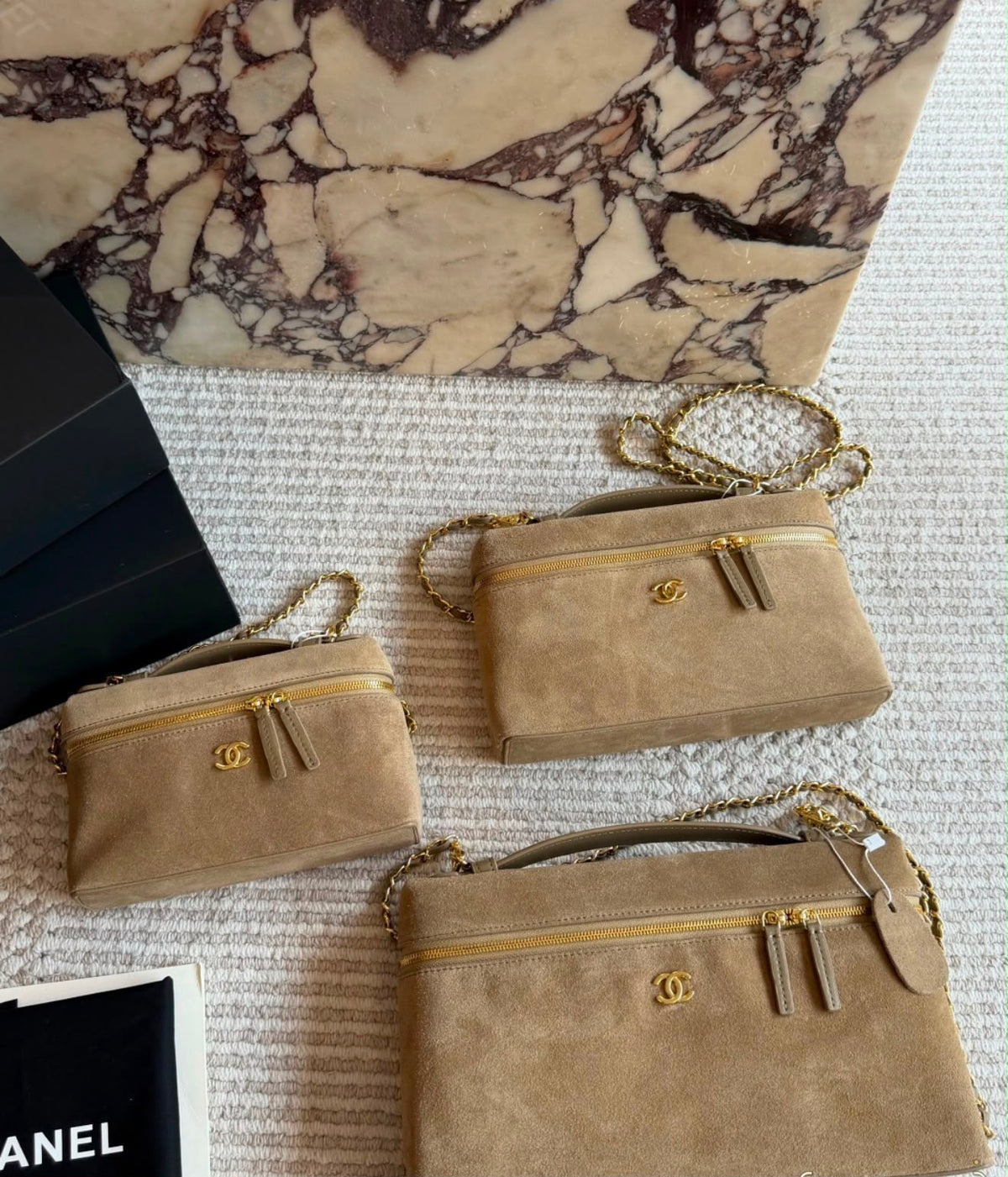 This is a Chanel Slim Long Vanity Case with Chain suede featuring gold tone hardware