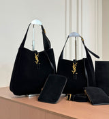 The Saint Laurent Le 5 à 7 Supple Large shoulder bag suede features the iconic gold-tone Cassandre hook closure and a relaxed, slouchy silhouette